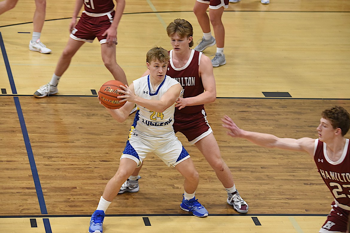 Libby's Alderic Martineau looks to pass against Hamilton on Thursday, Dec. 21, 2023. (Scott Shindledecker/The Western News)