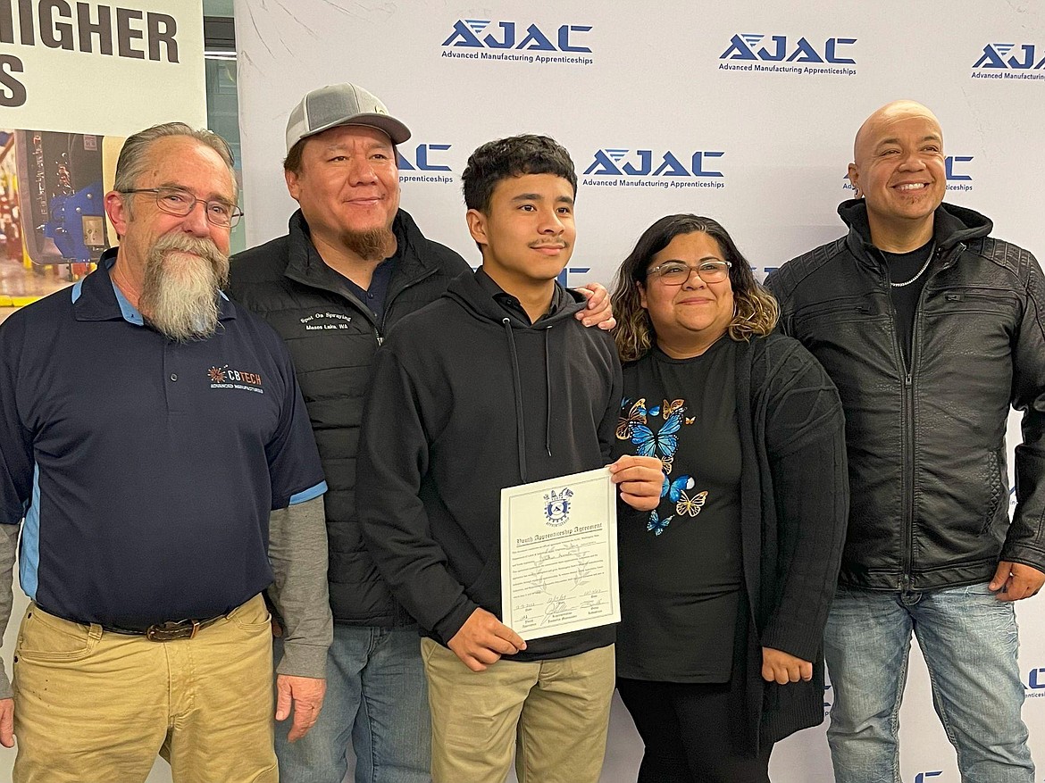 Apprentice Jonathan Avecedo Gutierrez, center, with his parents and teachers Dave Oliver, far left, and Amador Castro, far right, during the signing announcement.