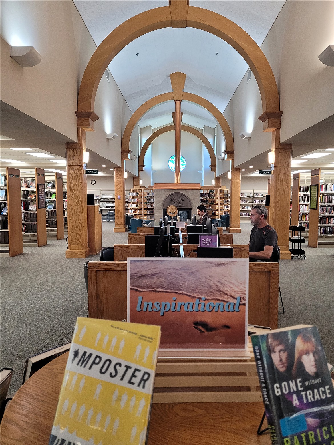 Patrons are seen beneath the wooden arches of the Post Falls Library in July. The Post Falls Library joined the Community Library Network in 2010 after residents voted to support the inclusion of the city of Post Falls into the boundaries of the Consolidated Free Library District.