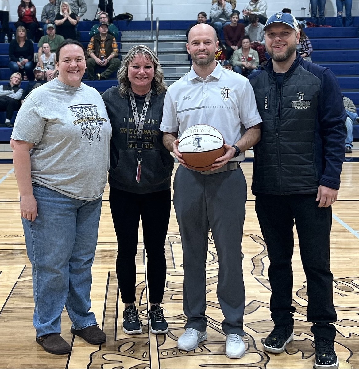 Courtesy photo
Timberlake girls basketball coach Matt Miller, in his 19th season as coach of the Tigers, was honored Wednesday after notching his 300th victory as Timberlake coach earlier this season. From left are Lakeland School District trustee Randi Bain, Timberlake High athletic director Catey Walton, Miller and Timberlake High principal Ryne Eberlin.