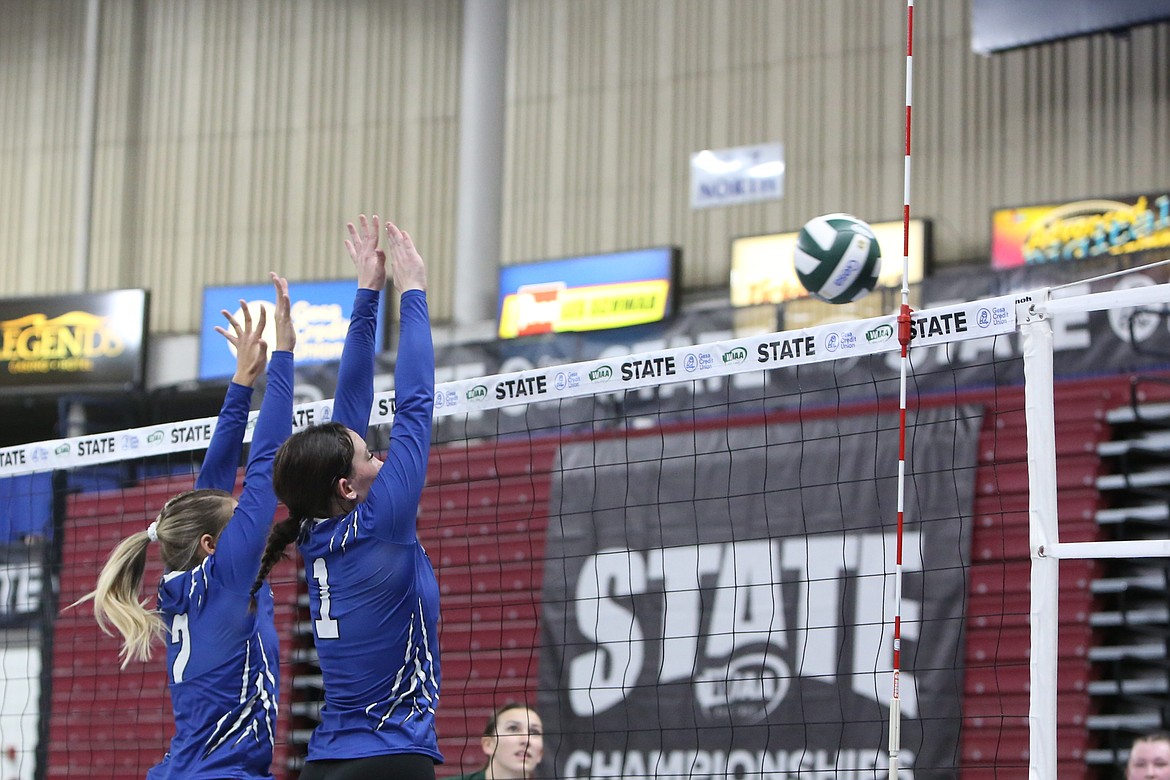 Soap Lake volleyball players Olivia McCrady (2) and Mylee Dana (1) go up for the block during a game at the 2023 1B state volleyball championship. Most extracurricular activities, including sports, are funded out of local educational programs and operations levies.