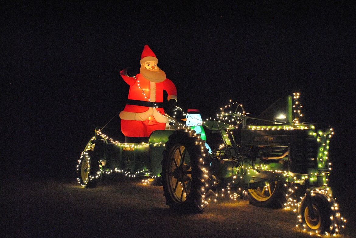 Out on Highway 135, Second place went to Curtis and Paula Mintz. Santa must have lost his reindeer, so he's improvising with a John Deere. That will surely get the job done! (Mineral Independent/Amy Quinlivan)