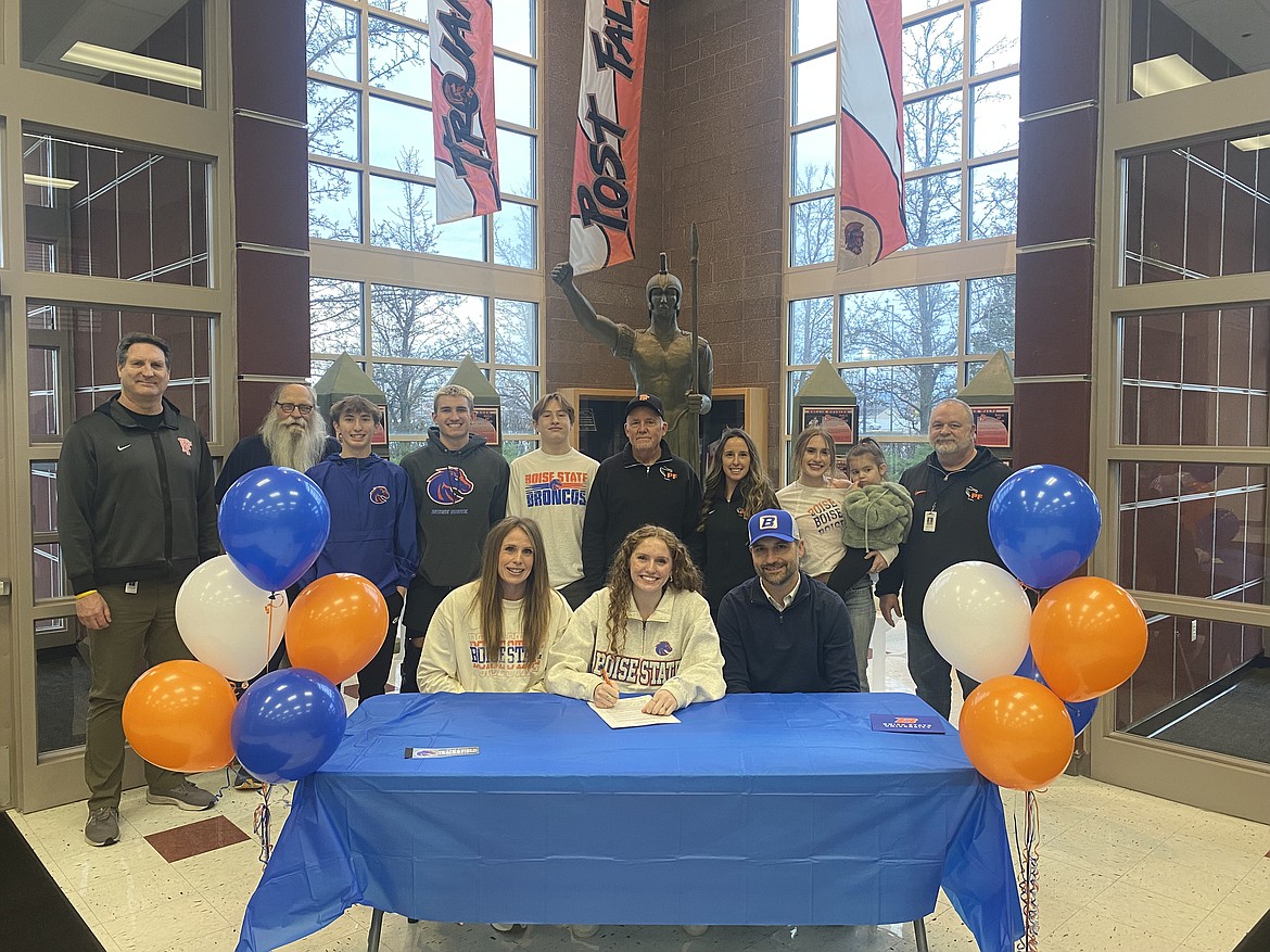 Courtesy photo
Post Falls High senior Kinlee McLean recently signed a letter of intent to run track at Boise State. Seated from left are Caroline McLean, Kinlee McLean and Nick McLean; and standing from left, Craig Christensen, Post Falls High athletic director; Tom Moores; Cobe Cameron; Dylan Wolfe; Asher McLean; Wade Quesnell, Post Falls High head track and field coach; Jessie Ward, Post Falls High assistant track and field and cross country coach); Skilar McLean; Harper Moores; and Dennis Amende, Post Falls High assistant track and field coach.