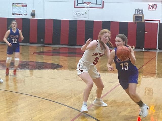 Superior guard Perri Jasper drives around Darby's Hadley Heland during their game Thursday night in Darby. (Photo by Byron Quinlan)