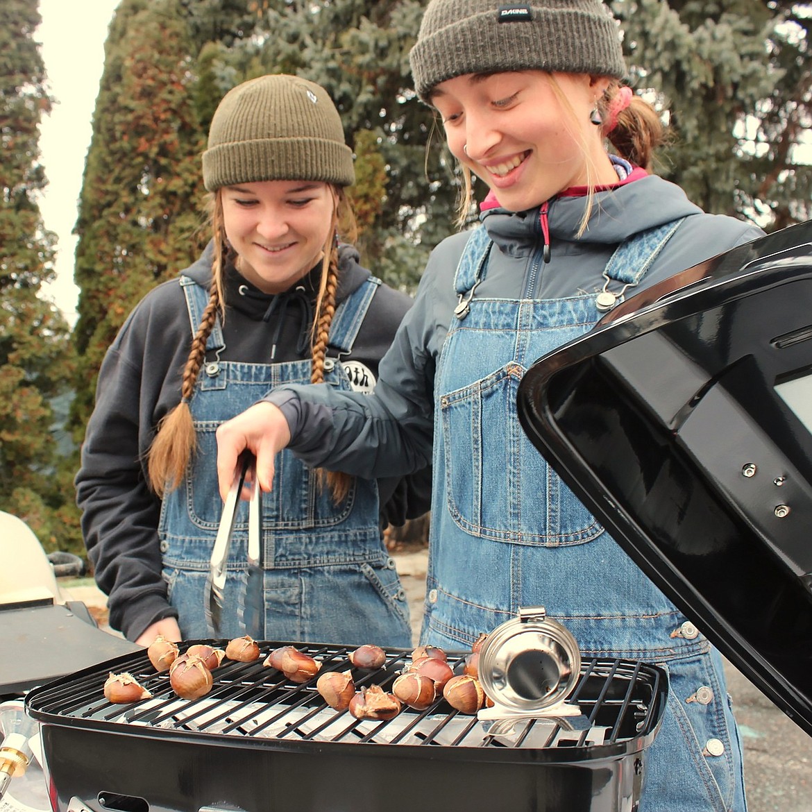 Sandpoint Waldorf School students roast chestnuts at a booth they were staffing at the school's annual Winter Faire.