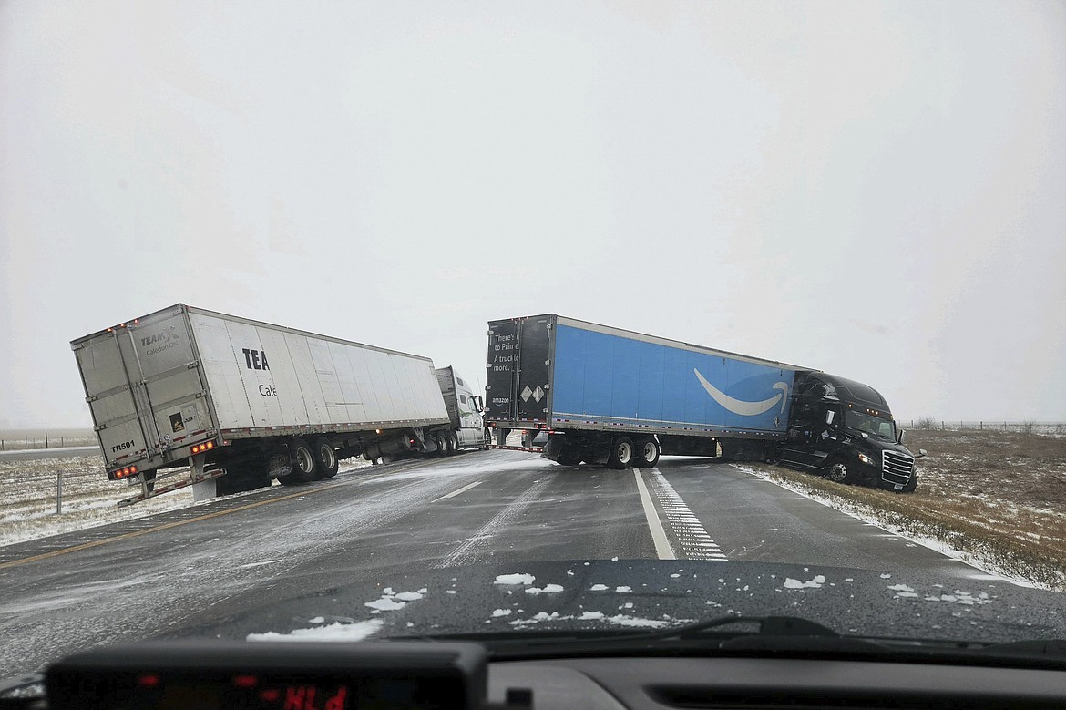 In this photo provided by Nebraska State Patrol, two tractor-trailers lose control on Christmas Day on Interstate 80 in Nebraska as a winter storm pummels part of the Midwest, on Monday, Dec. 25, 2023. Forecasters are predicting that heavy snow and blizzard conditions will continue through early Wednesday across part of the north-central U.S. (Nebraska State Patrol via AP)