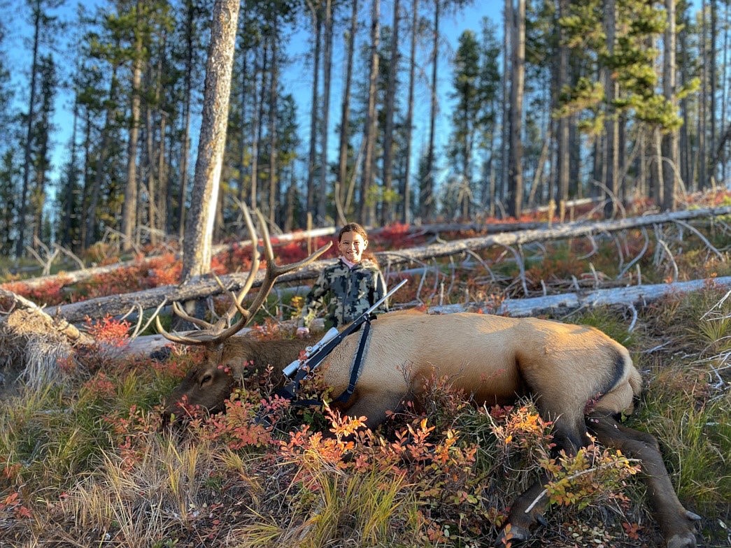 Inslee Moran of Arlee, who is one of the winners of the 2023 Governor’s Youth Hunting Story Contest, poses with the elk she shot. (Courtesy photo)