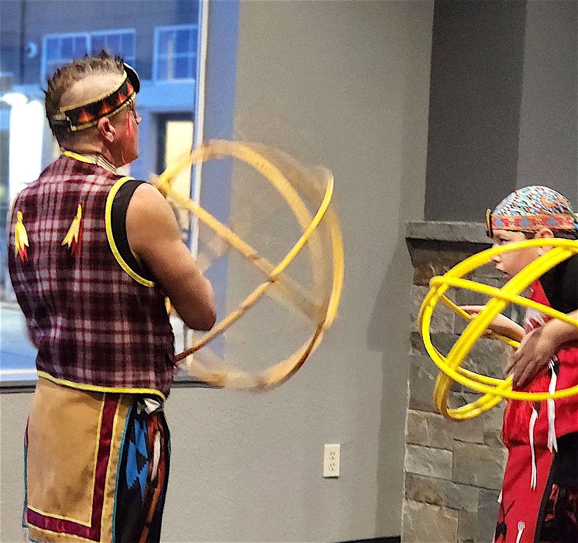 JR Parot and his son Ryder warm up for their hoop dance during the Warming Center benefit on Dec. 20. (Berl Tiskus/Leader)