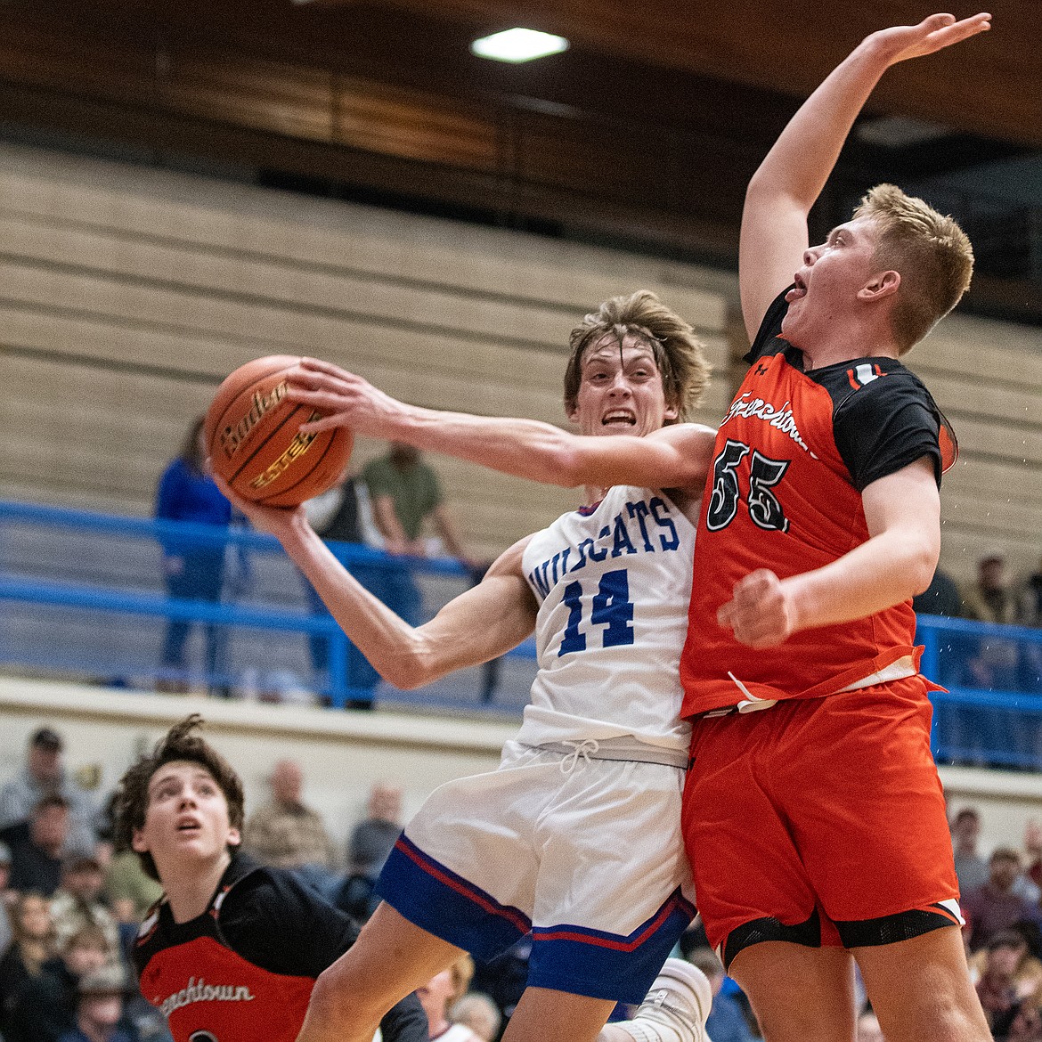 Wildcat Jace Hill makes a pass around Frenchtown’s Henry Griffin on Tuesday, Dec. 19. (Avery Howe photo)