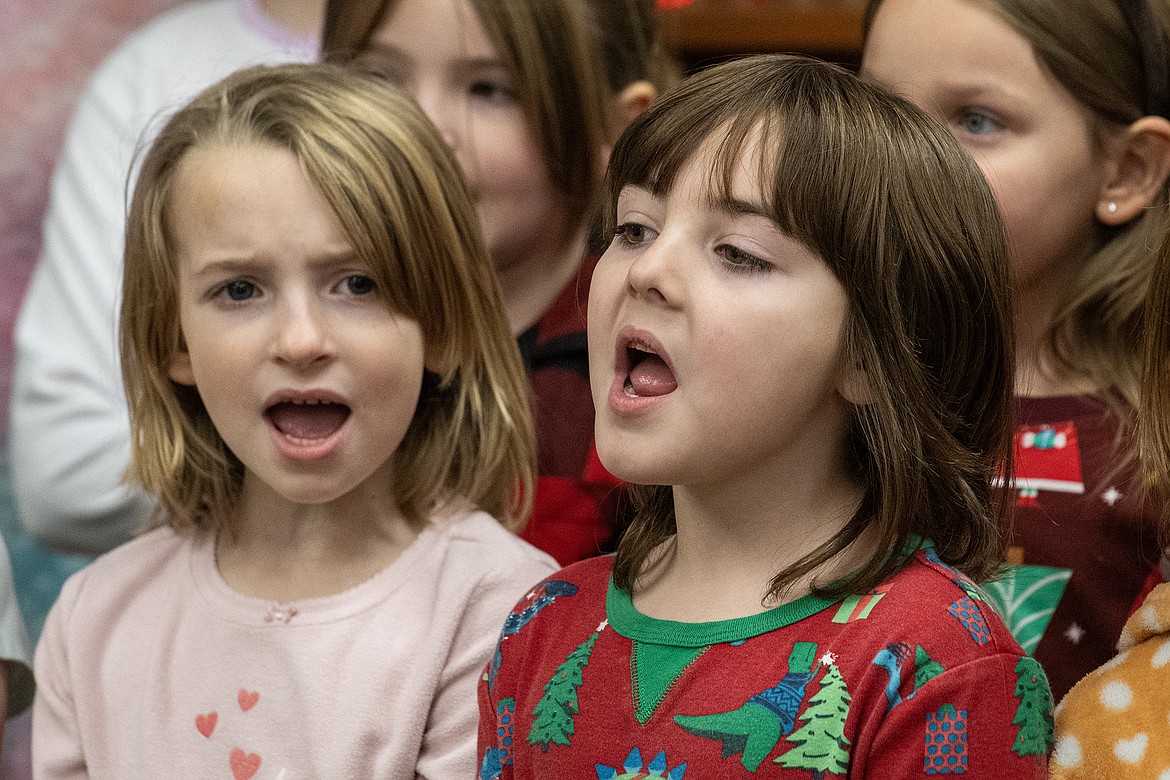 Aileana McMullin and Bridget Poor carol at Montana Veterans Home with the rest of Mrs. Getts’s first grade class on Wednesday, Dec. 20. This was the first time the Glacier Gateway students were able to continue this tradition after the Covid-19 pandemic. (Avery Howe photo)