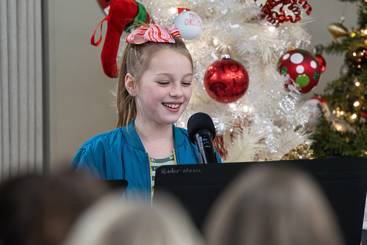 Ruder Elementary Schooler Evelyn Bjornrud reads her lines as a joking elf in the third grade holiday music concert on Tuesday, Dec. 19. (Avery Howe photo)