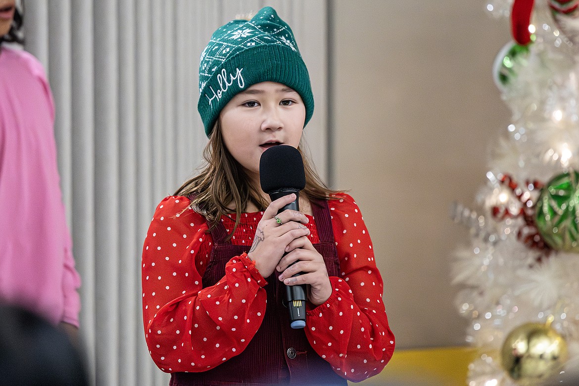 Fourth grader Cora Reinbolt  sings a solo in Ruder Elementary School’s holiday performance on Tuesday, Dec. 19. (Avery Howe photo)