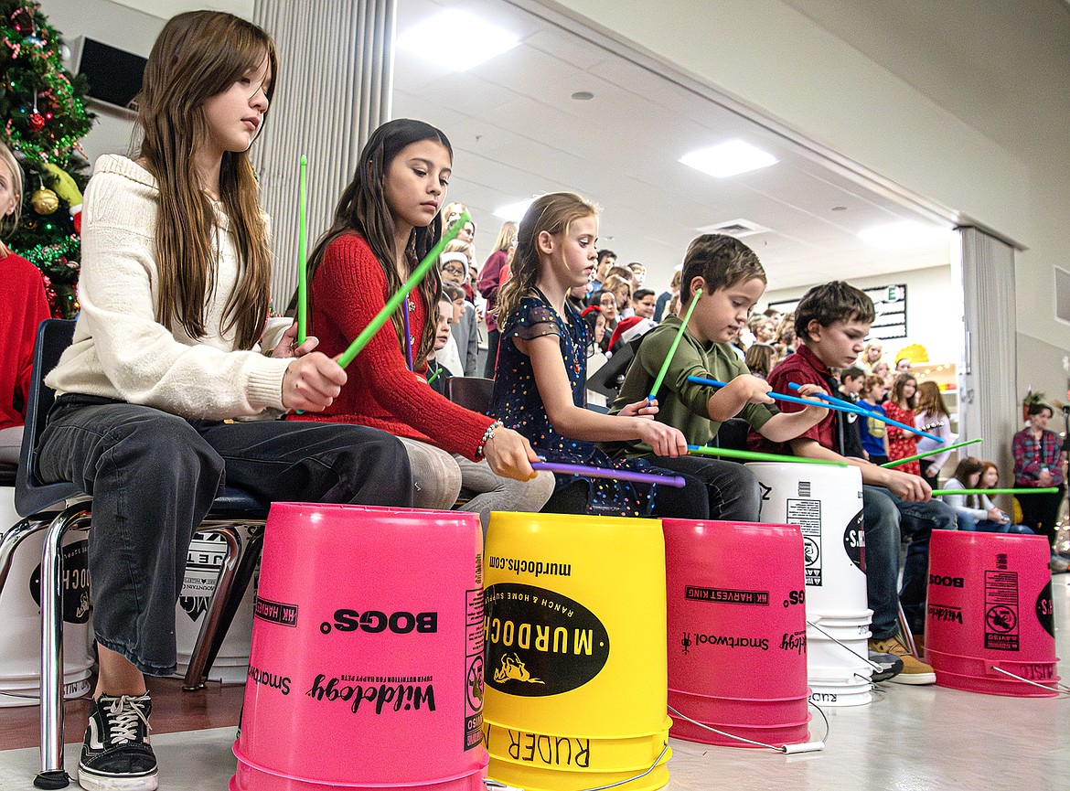 Fifth graders Sadie Price, Lyla McDonald, Keaghan Hawkins, Weston Kiser, and Jovanni Gneiting play the bucket drums for Ruder Elementary School’s holiday performance on Tuesday, Dec. 19. (Avery Howe photo)