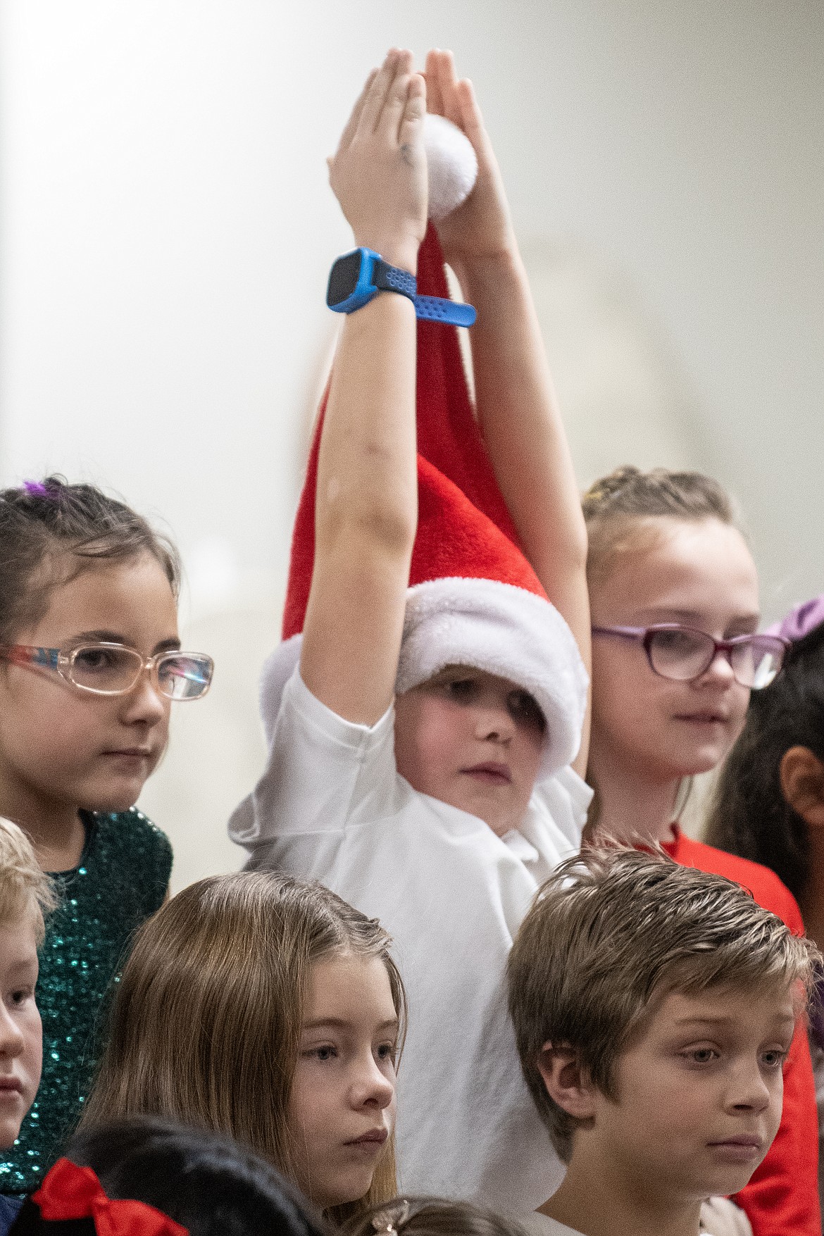 Ruder Elementary second grader Cameron Rice stands up his Santa hat for the holiday concert on Wednesday, Dec. 20. (Avery Howe photo)