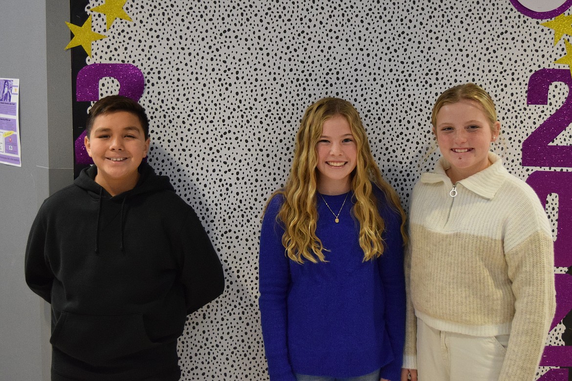 Scootney Springs Elementary sixth-grade leadership students Manuel Gallegos, Kinsley Roylance and Abigail Prows stand in front of the corner where a Scootney Springs food drive slowly collected dog food for Adams County Pet Rescue. The sixth-grade leadership class helped run the food drive.