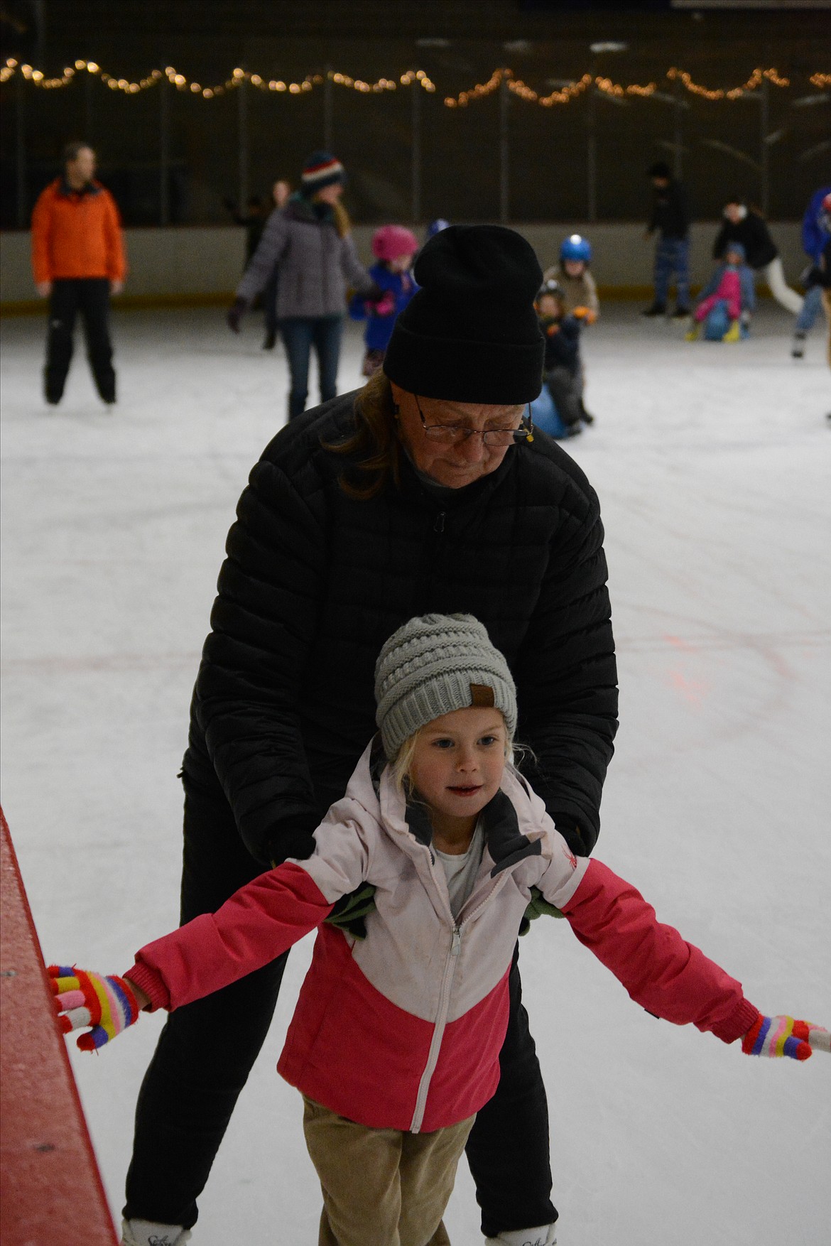 Laima Langley and Livia Kjell make their way around the rink together as Livia learns to skate.