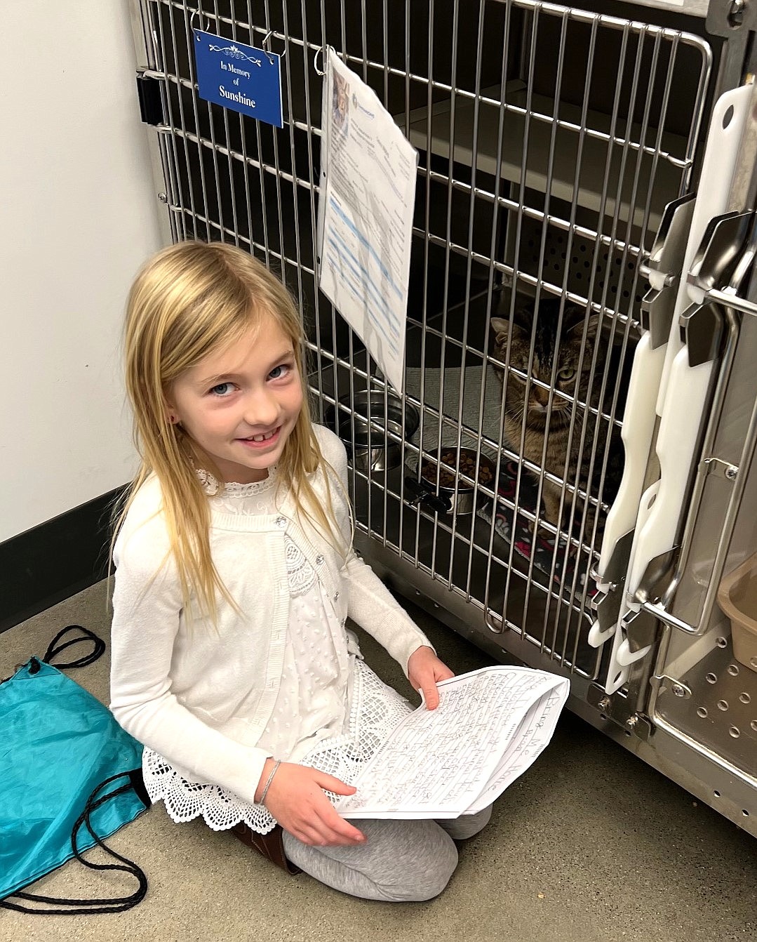 Adi Thompson, a student at Northwest Expedition Academy. reads to a cat at Companions Animal Center.