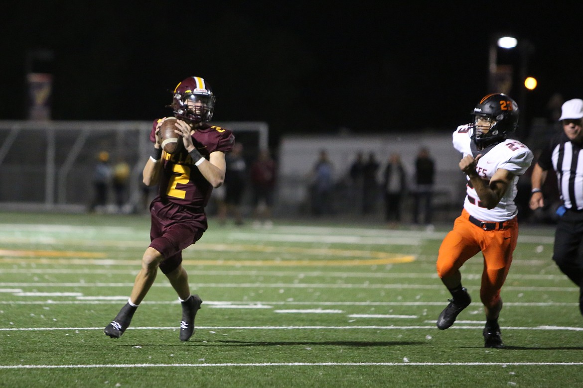 Moses Lake sophomore Brady Jay, left, rolls out to pass against Davis. Jay and his father, Moses Lake Head Coach Brett Jay, made an appearance on last week’s episode of the STUDIO BASIN podcast.