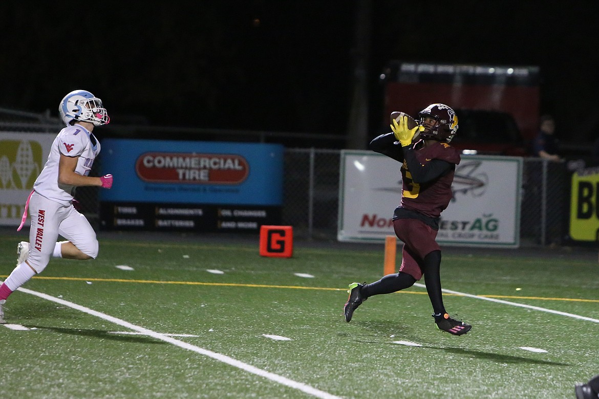 Moses Lake senior Joel Middleton, right, catches a pass against West Valley (Yakima).