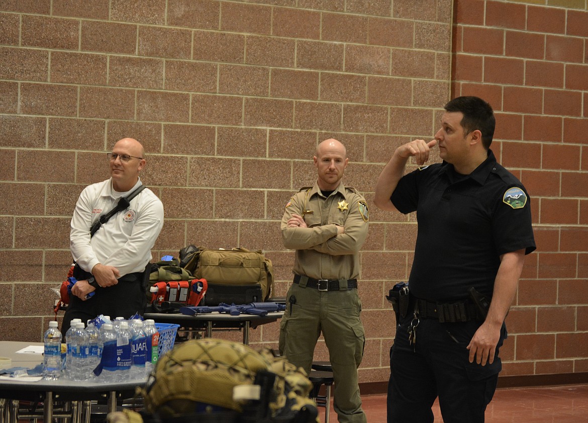 Scott Dietrich and Seth Green listen as Dameon Groves of Kellogg Police addresses assembled law enforcement officers and firefighter/EMS staff at Wallace High School Thursday morning. The briefing detailed some helpful ways for first responders to organize in the event of active shooter scenarios.