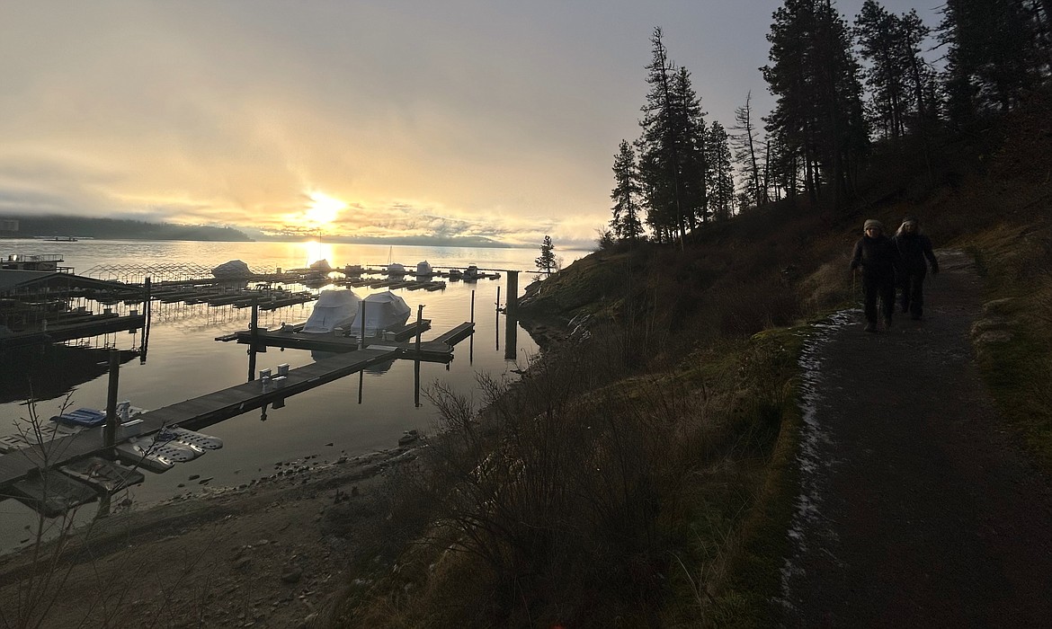 A rising sun greets hikers as they follow a Tubbs Hill trail Thursday morning