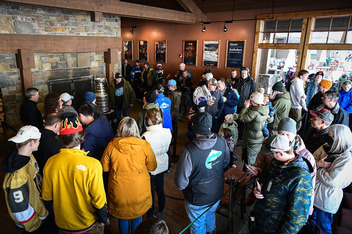 Fans stand in line to have their picture taken with the Stanley Cup inside Whitefish Mountain Resort's Base Lodge on Friday, Dec. 29. The trophy made a stop on Big Mountain as the defending NHL champion Vegas Golden Knights and Whitefish Mountain Resort are both owned by Foley Entertainment Group. (Casey Kreider/Daily Inter Lake)