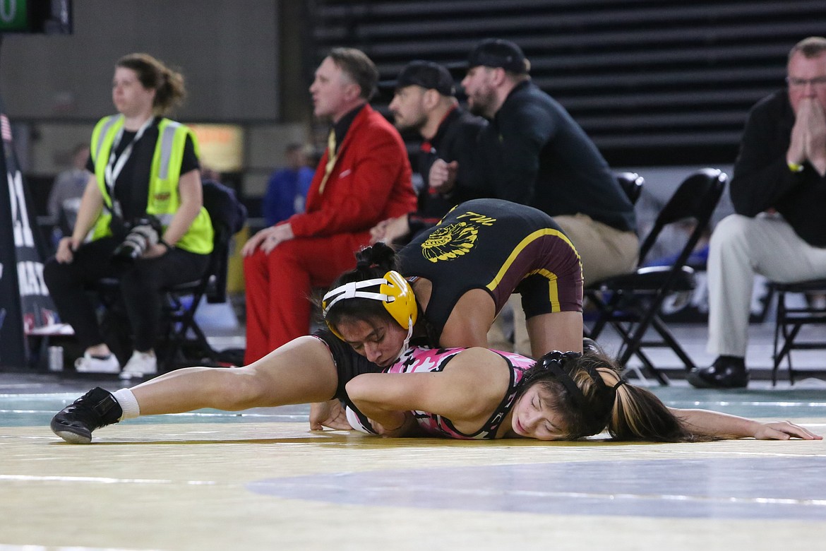 Moses Lake senior Ashley Naranjo, top, wrestles against  Kira Songer of Marysville-Getchell, bottom, in the finals of the girls 115-pound bracket at the 2023 Mat Classic.