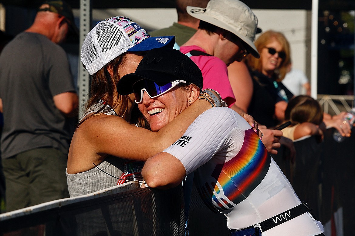 Krista Lapan embraces a friend at the finish line after completing her her 16th Ironman. She was the first local woman to finish the race in June.