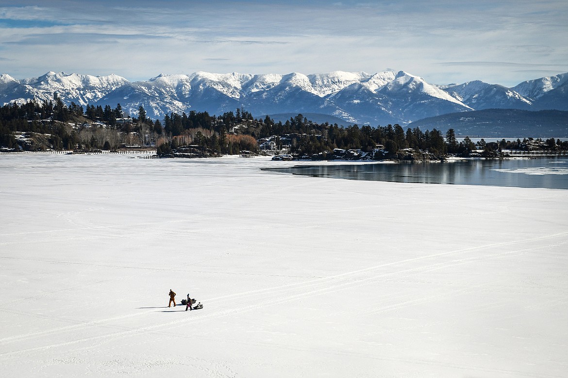 Two anglers haul their ice fishing gear across the frozen surface of Flathead Lake near Somers on Thursday, Feb. 9. (Casey Kreider/Daily Inter Lake)