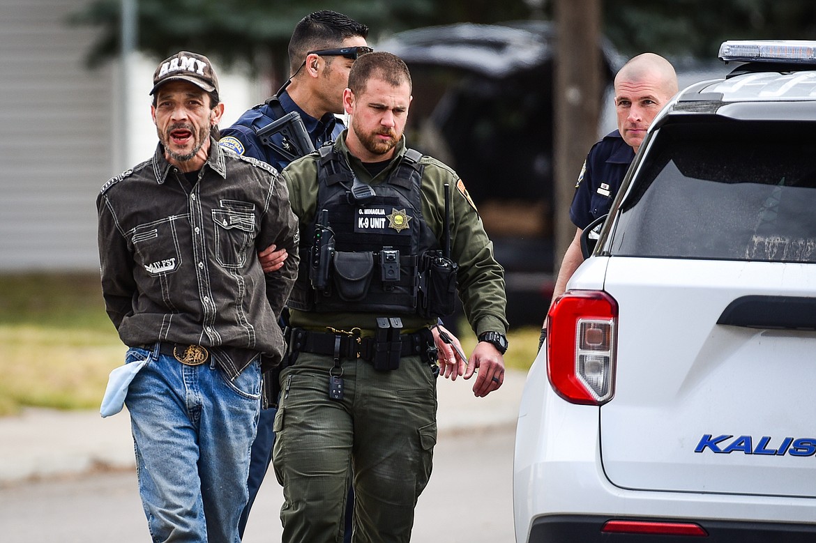 Law enforcement personnel take a suspect into custody after an assault with a weapon call turned into an armed standoff between Second and Third Avenue West North in Kalispell on Tuesday, April 11. (Casey Kreider/Daily Inter Lake)