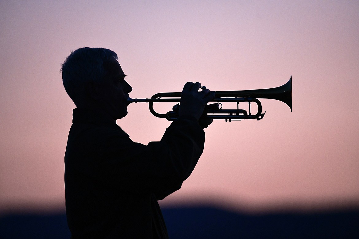 A Marine bugler plays Taps at dusk at The Wall That Heals at the Glacier High School soccer fields on Thursday, June 22. (Casey Kreider/Daily Inter Lake)