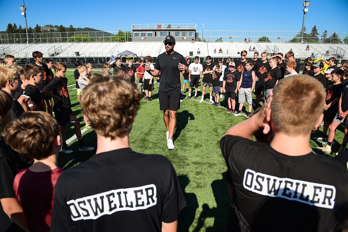Former NFL and Flathead Braves quarterback Brock Osweiler speaks with campers at the start of a pair of free football camps hosted by Osweiler at Legends Stadium in Kalispell on Saturday, July 1. (Casey Kreider/Daily Inter Lake)