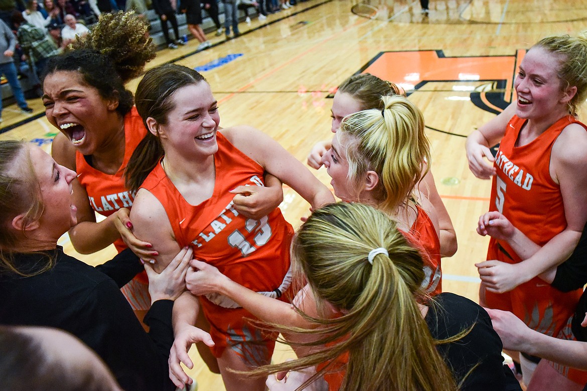 The Bravettes celebrate after Avery Chouinard's (13) game-winning three-pointer as time expired against Missoula Hellgate in the Western AA Divisional Championship at Flathead High School on Saturday, March 4. (Casey Kreider/Daily Inter Lake)