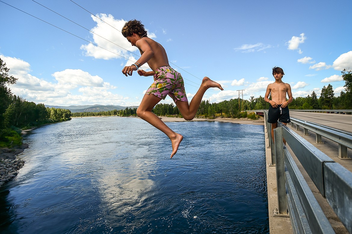 Tayton Hardman leaps off a bridge into the Flathead River with his friend Fischer Lee in Evergreen on Tuesday, July 25. (Casey Kreider/Daily Inter Lake)