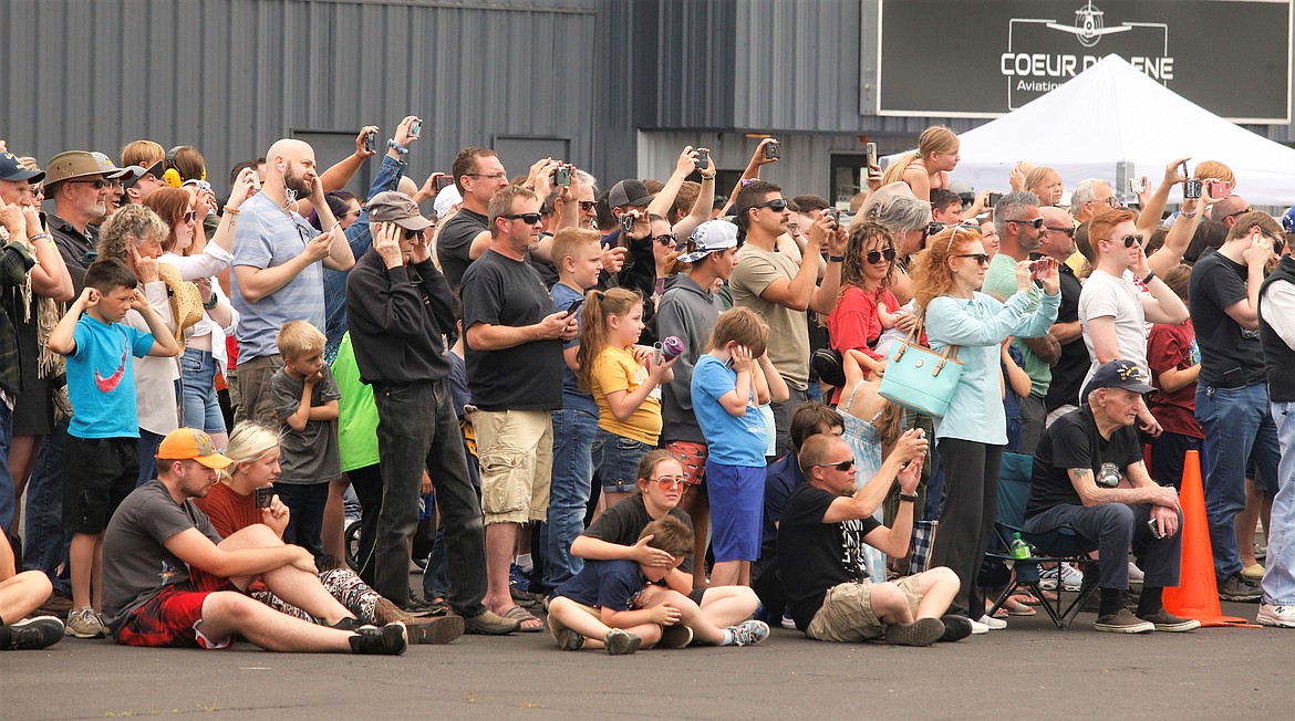 Crowd members take pictures and plug their ears as the F-35s prepare for takeoff at the Coeur d'Alene Airport in June.