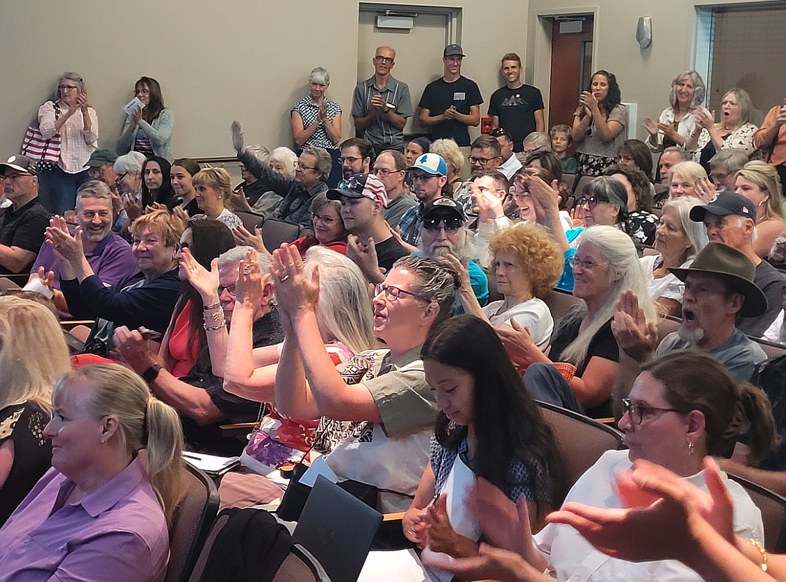 KMPO: Attendees applaud a speaker who opposes a regional traffic management center during a Kootenai Metropolitan Planning Organization board meeting in June at Post Falls City Hall.