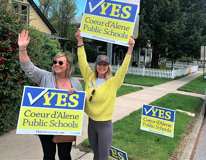 Jamie Smee, left, and Amy Hobson rally support for the Coeur d'Alene School District outside St. Thomas Center during the May levy election.