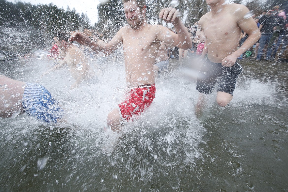 People plunge into Lake Coeur d'Alene on Jan. 1, 2023 during the Polar Bear Plunge.