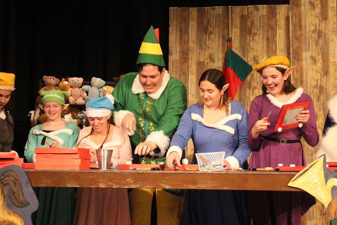 The cast of the Masquers Theater production of “Elf” busily make toys.