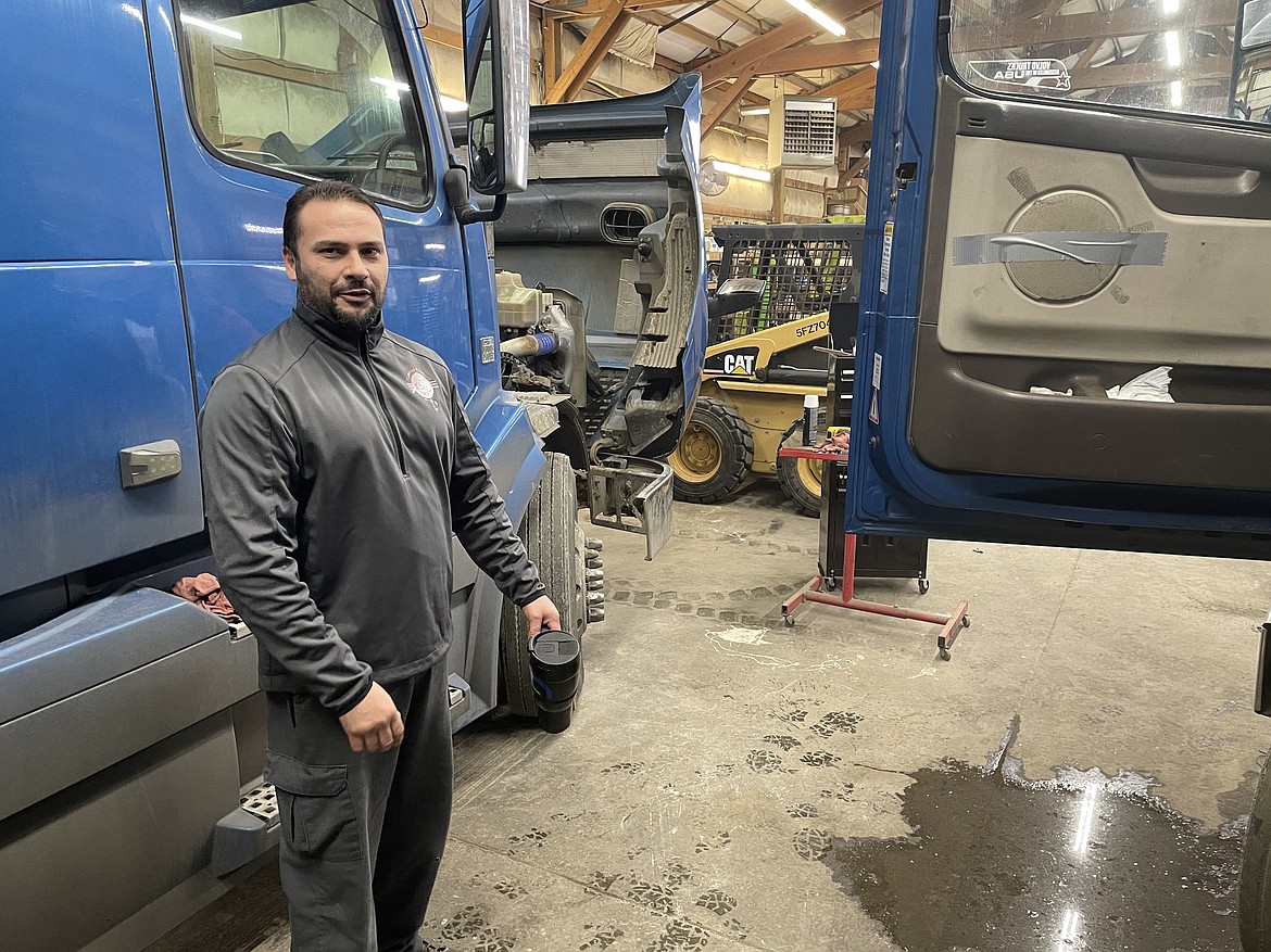 Othello-based company Flamingo Trucking owner Peter Garza stands in Flamingo Trucking’s repair bay, showing the inside of a truck cab in January 2021.