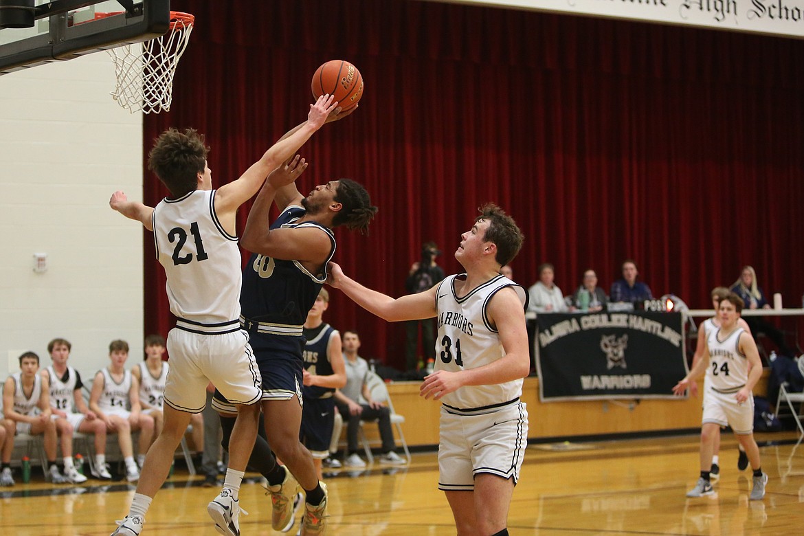 MLCA/CCS senior Caleb Jones, in blue, drives toward the rim against ACH Saturday.