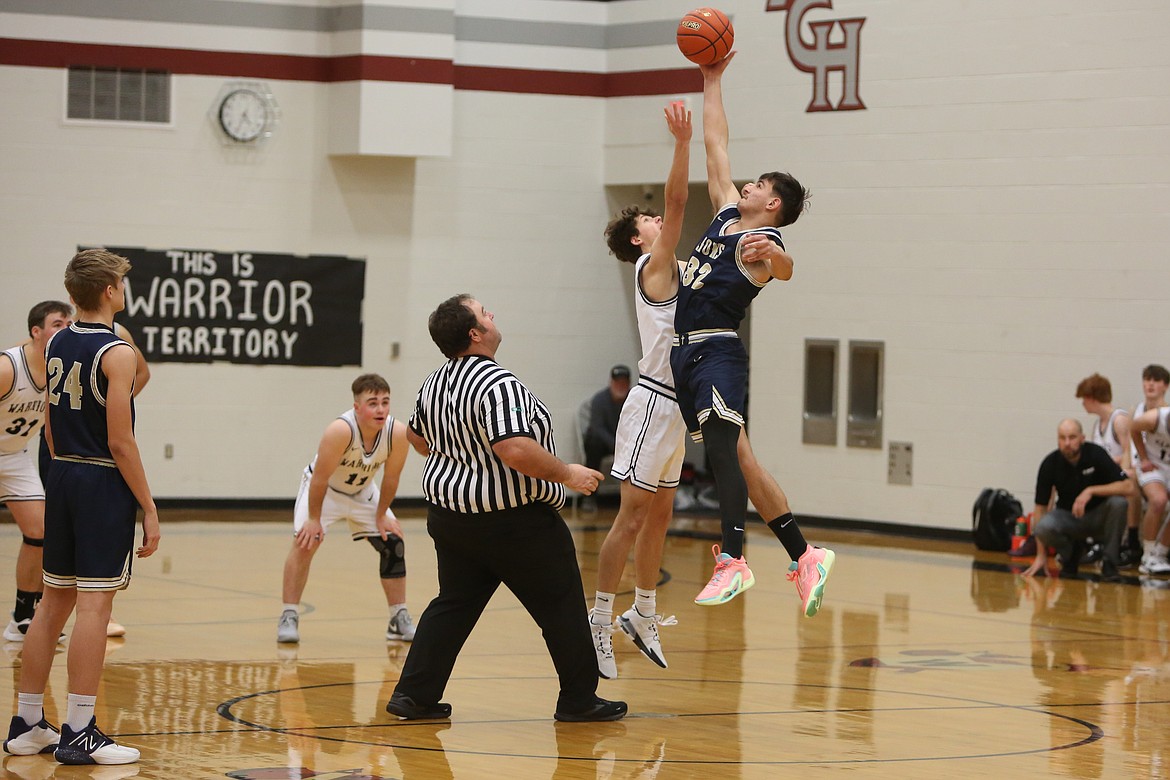 MLCA/CCS sophomore Dennis Gulenko (32) grabs the opening tip-off against ACH Saturday night.