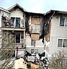 Police kick in door, carry woman from burning unit