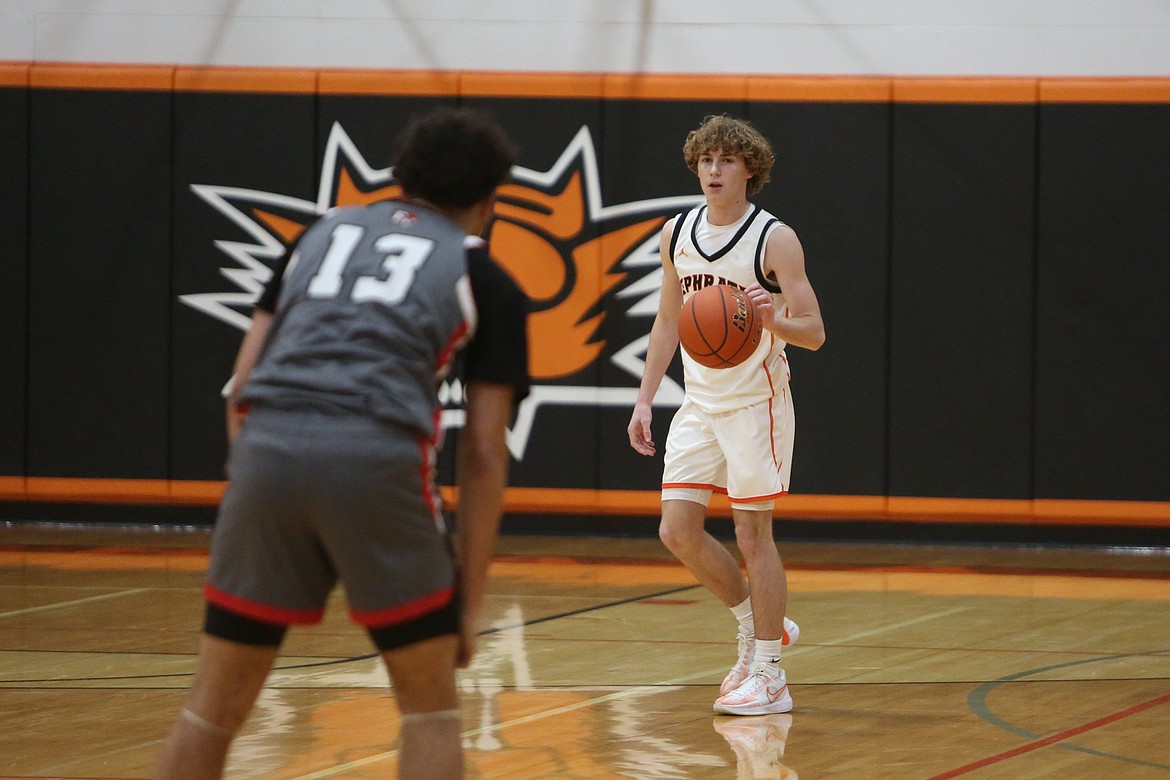 Ephrata junior Payton Riggs, in white, brings the ball up the floor against East Valley (Yakima). The Ephrata boys defeated the Red Devils 51-49 Tuesday night.