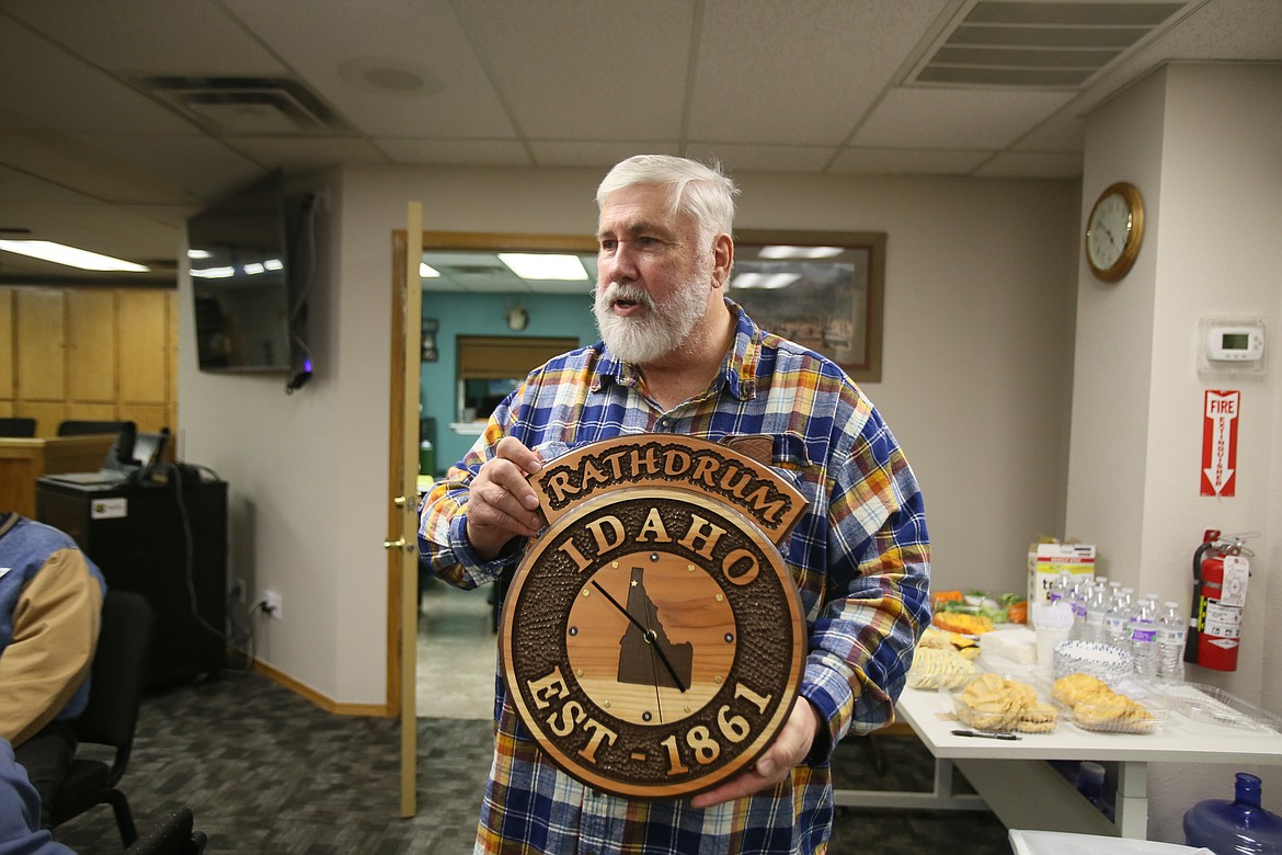 Outgoing Rathdrum Mayor Vic Holmes displays a handmade gift from Radiant Lake neighborhood resident Dan Boerner during Holmes' retirement party Wednesday.
