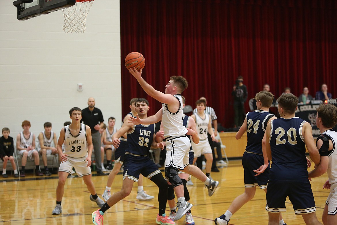 ACH junior Carter Pitts, with the ball, drives toward the rim for a layup in Saturday’s game against MLCA/CCS.