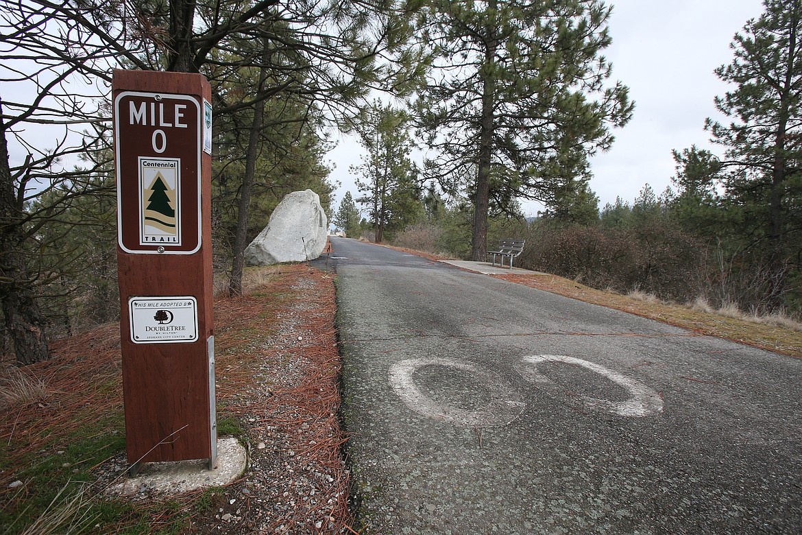 Lichens and cracks can be seen Friday near the faded mile marker paint on the North Idaho Centennial Trail.