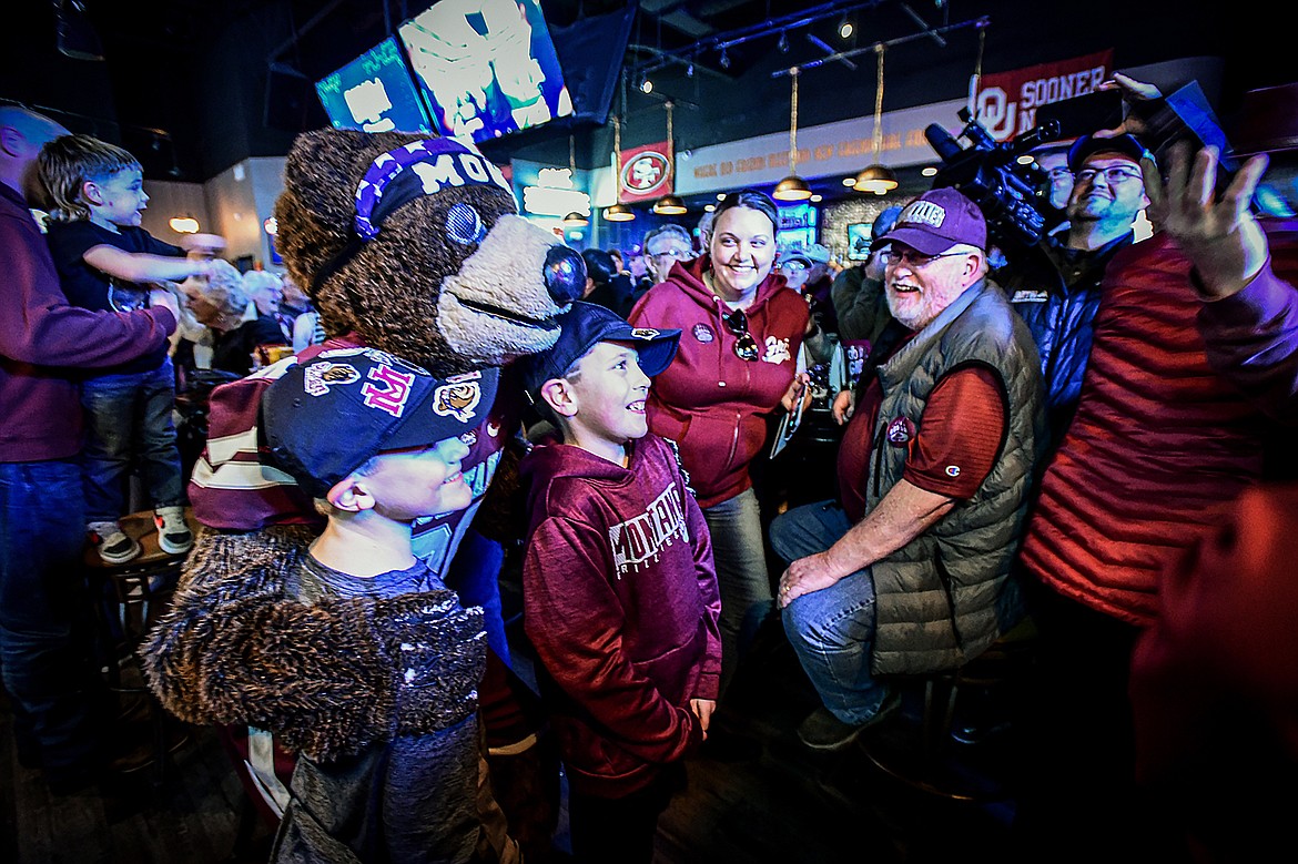 Monte takes photos with fans during a Griz Gathering held at Frisco Bar & Grill in Frisco, Texas, on Friday, Jan. 5. (Casey Kreider/Daily Inter Lake)