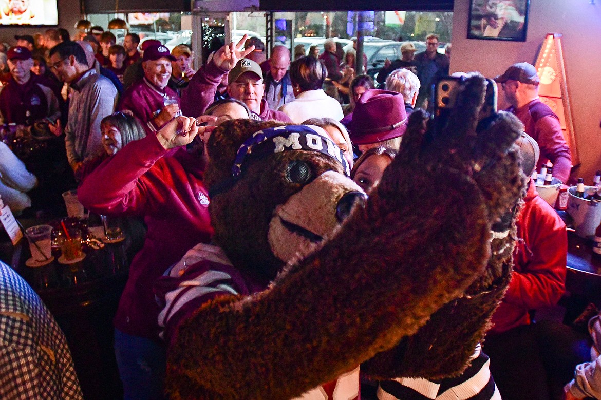 Monte takes photos with fans during a Griz Gathering held at Frisco Bar & Grill in Frisco, Texas, on Friday, Jan. 5. (Casey Kreider/Daily Inter Lake)