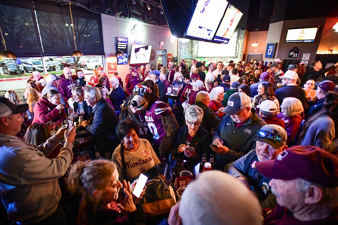 Monte takes photos with fans during a Griz Gathering held at Frisco Bar & Grill in Frisco, Texas, on Friday, Jan. 5. (Casey Kreider/Daily Inter Lake)